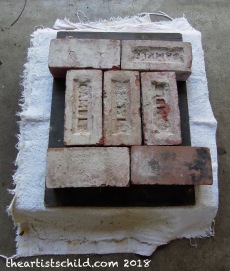Bricks act as weights on press